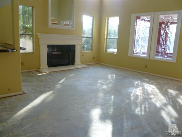 11667 Pinedale Road Moorpark, CA 93021 - Photo 4 of 7 a view of an empty room with a fireplace and a window