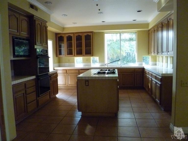11667 Pinedale Road Moorpark, CA 93021 - Photo 7 of 7 a kitchen with stainless steel appliances granite countertop a stove a sink and a refrigerator
