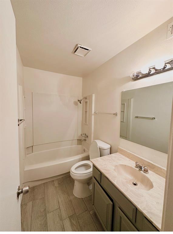 4472 Chaha Road, Unit 104 Garland, TX 75043 - Photo 4 of 5 Full bathroom featuring a white tub/shower combination, tile-finish flooring, a vanity with an integrated sink, and an overhead light fixture