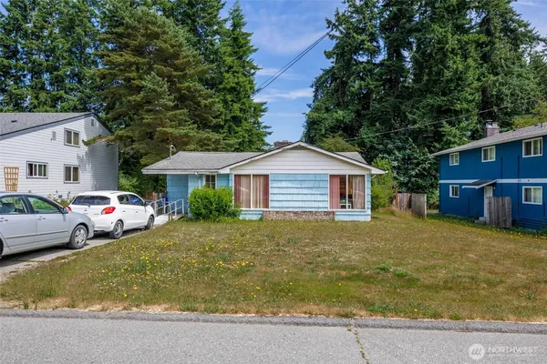 a front view of house with yard and trees