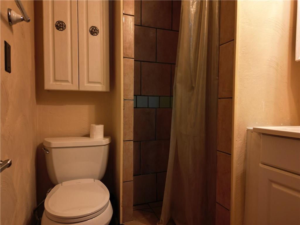 1119 Layton Road Butler, PA 16001 - Photo 15 of 25 a white toilet sitting next to a bathroom sink