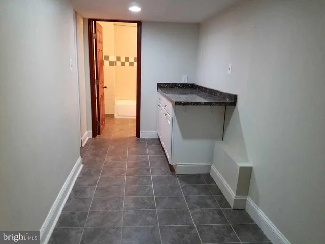 a bathroom with a granite countertop sink a toilet and a mirror