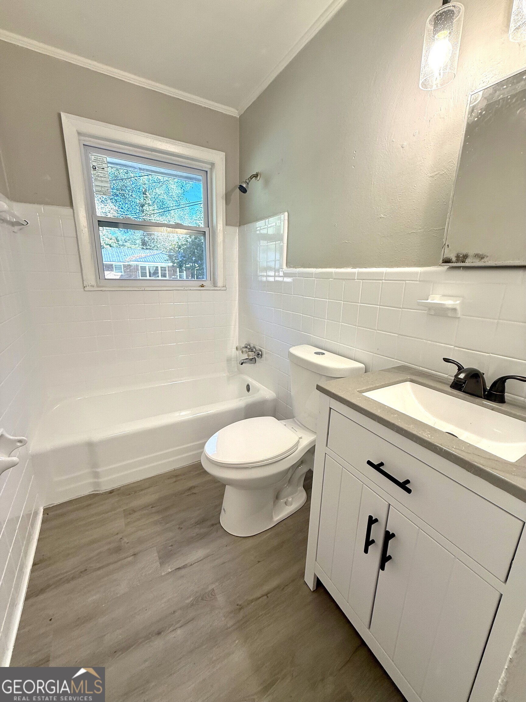 226 Poplar Street Toccoa, GA 30577 - Photo 11 of 17 a bathroom with a toilet a sink and mirror