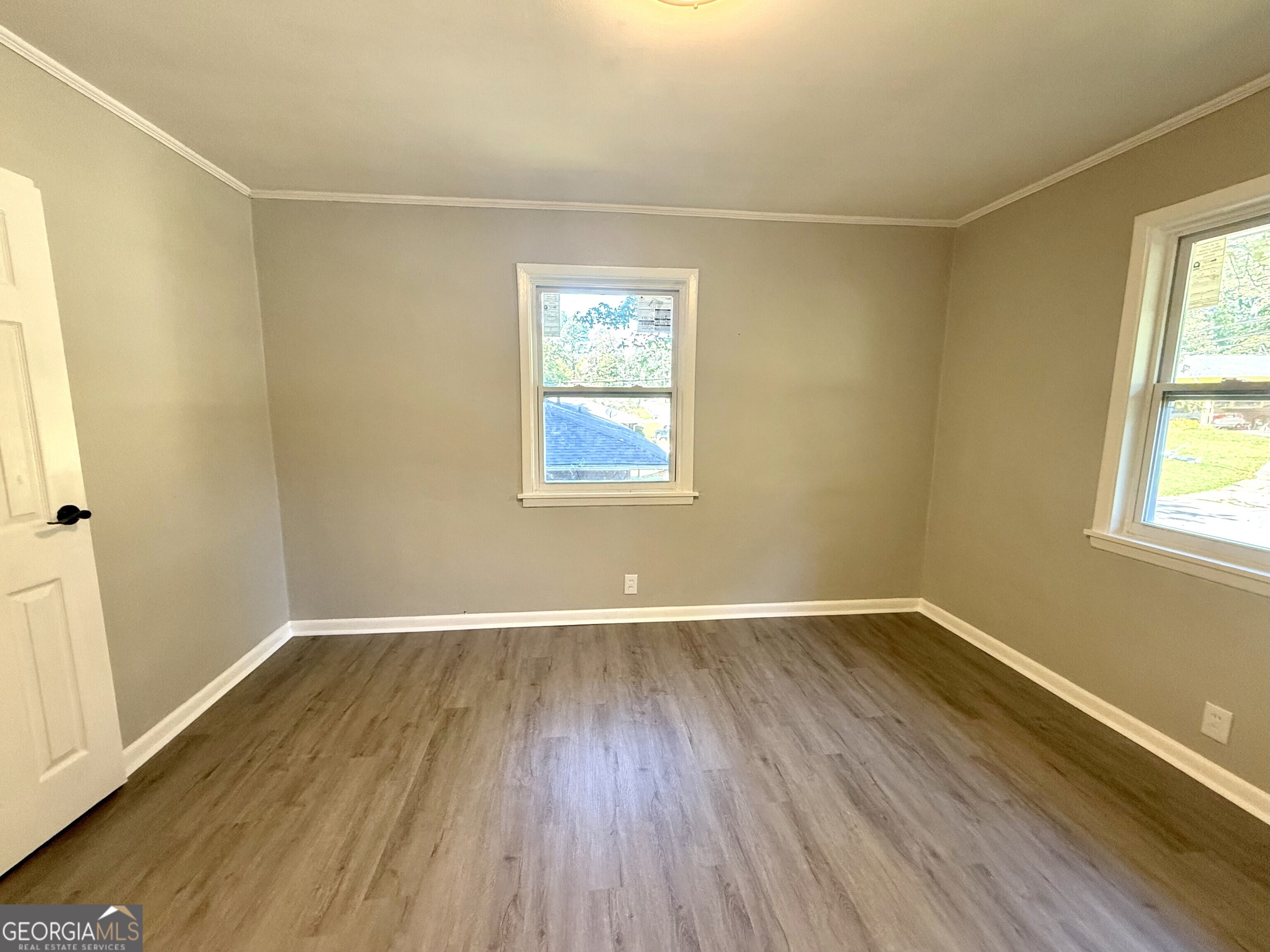 226 Poplar Street Toccoa, GA 30577 - Photo 10 of 17 an empty room with wooden floor and windows