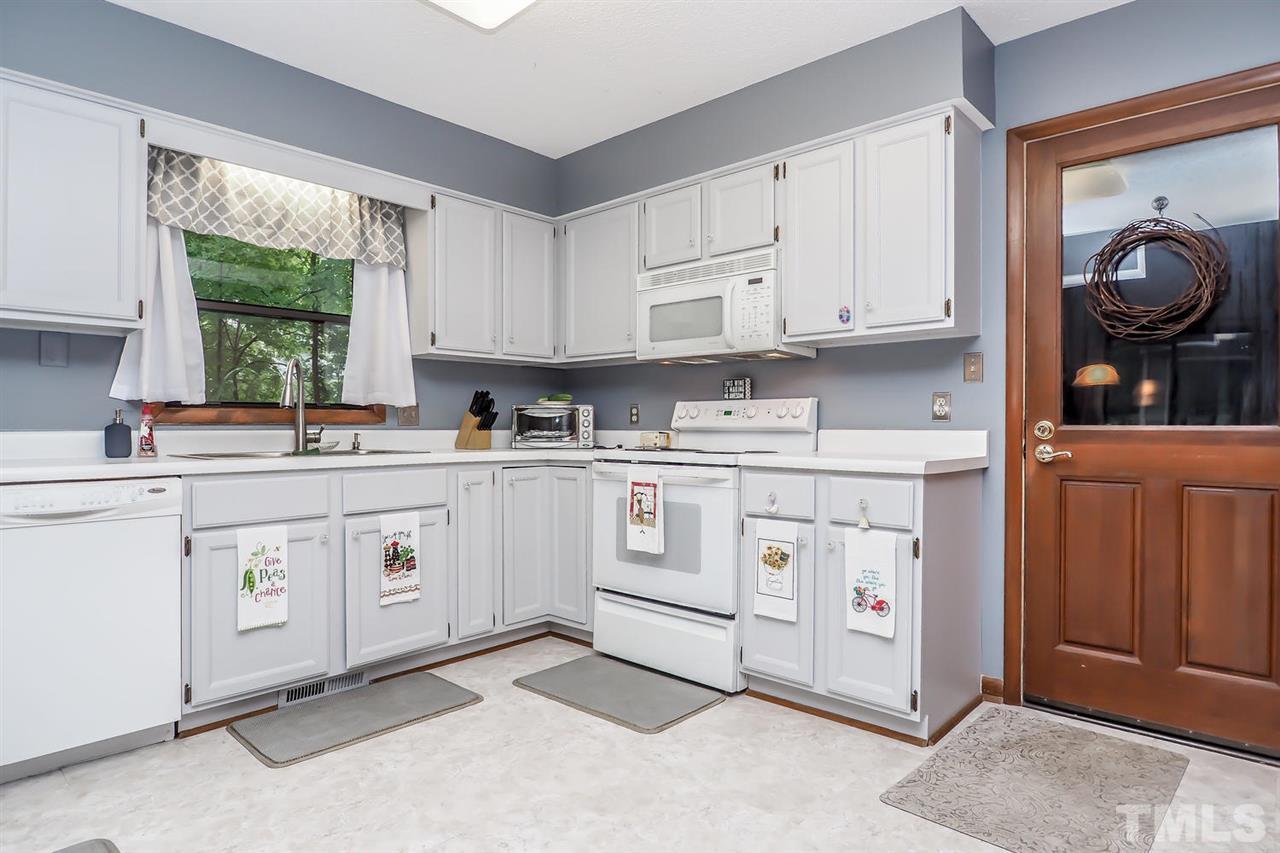 8804 Life Lane Raleigh, NC 27615 - Photo 14 of 25 a kitchen with cabinets appliances and a window