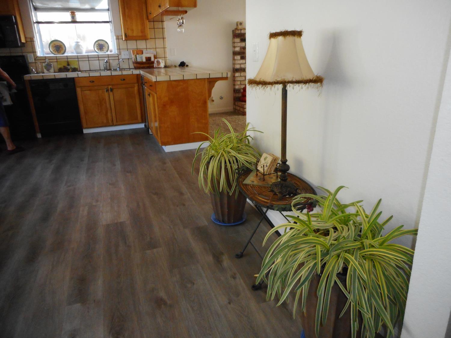 1432 Don Pedro Road Ceres, CA 95307 - Photo 14 of 56 a close view of chair and potted plant on a wooden floor
