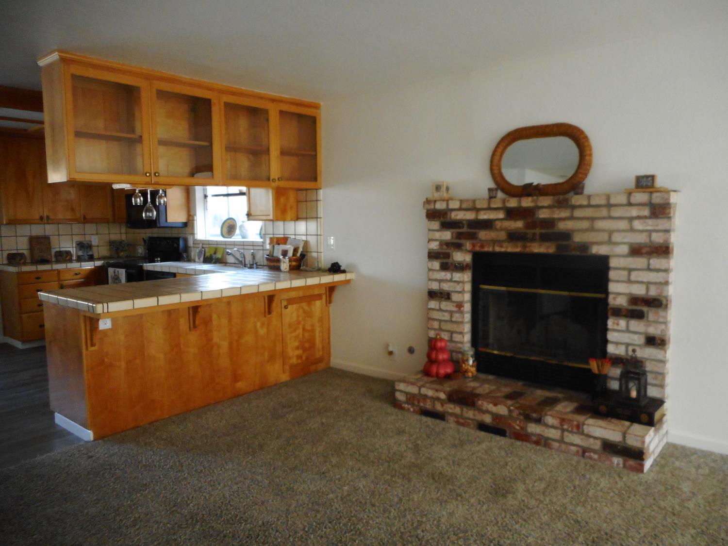 1432 Don Pedro Road Ceres, CA 95307 - Photo 16 of 56 a living room with furniture a fireplace and a floor to ceiling window