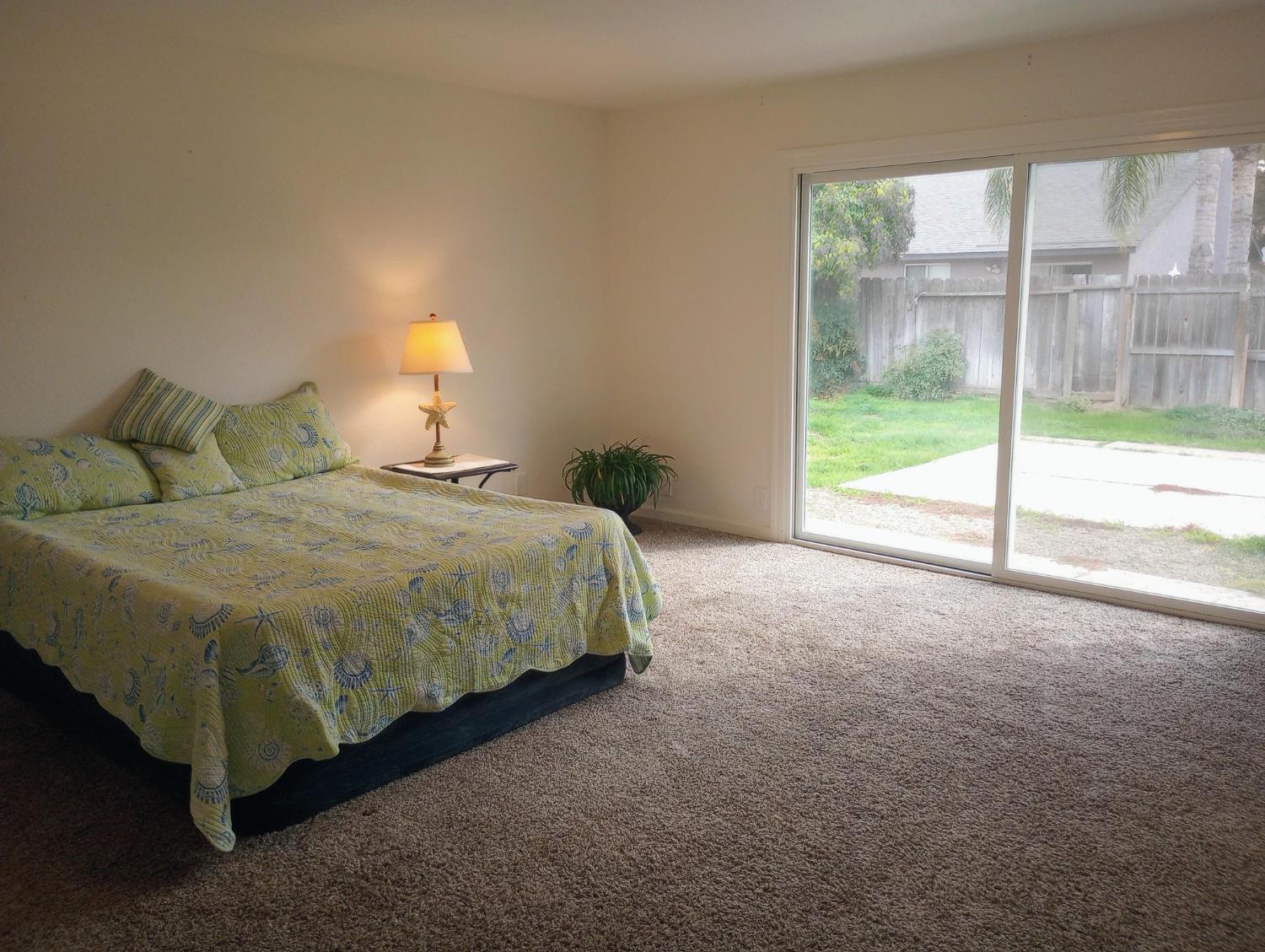 1432 Don Pedro Road Ceres, CA 95307 - Photo 20 of 56 a bed sitting in a bedroom next to a window