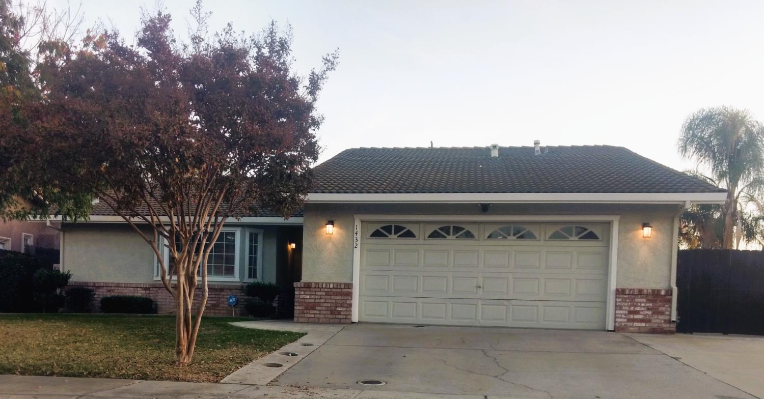 1432 Don Pedro Road Ceres, CA 95307 - Photo 2 of 56 a front view of a house with a yard and garage