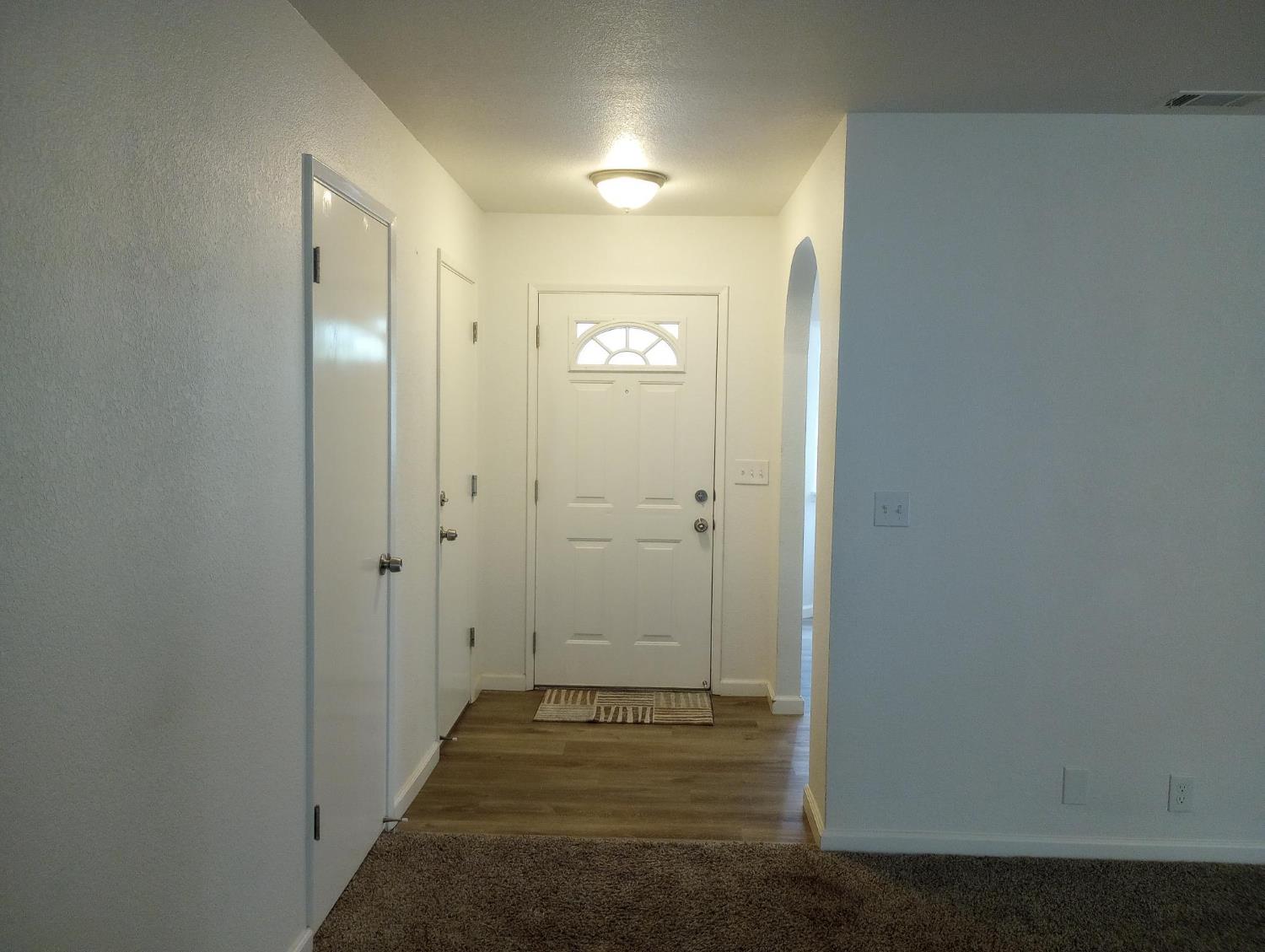 1432 Don Pedro Road Ceres, CA 95307 - Photo 4 of 56 a view of a hallway with wooden floor and a bathroom