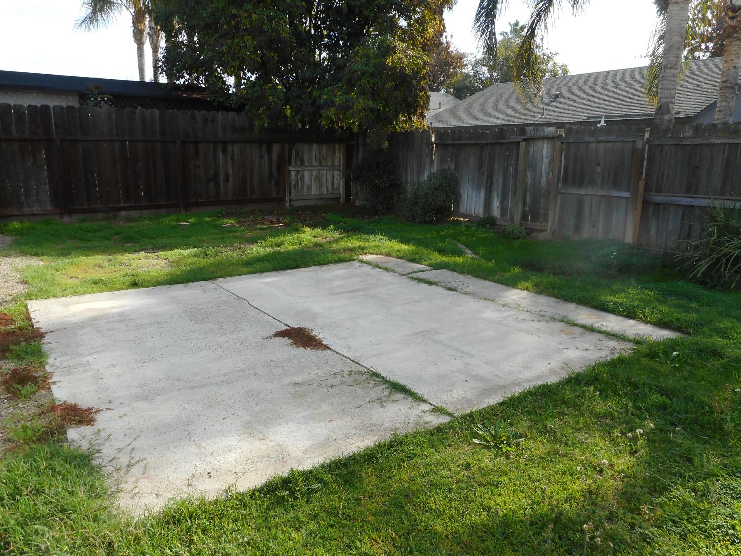 1432 Don Pedro Road Ceres, CA 95307 - Photo 47 of 56 a view of a backyard with a small cabin and wooden fence