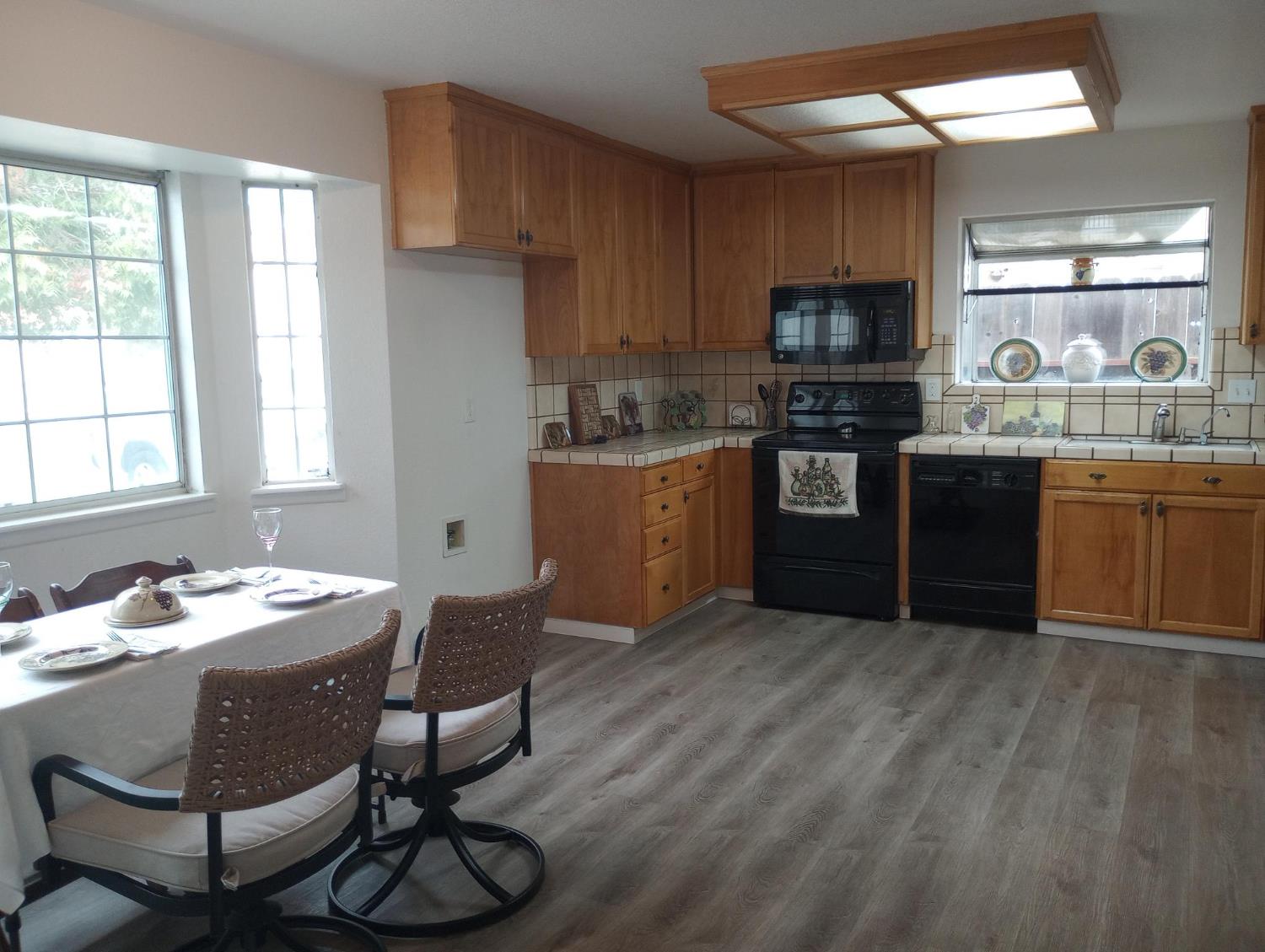 1432 Don Pedro Road Ceres, CA 95307 - Photo 7 of 56 a kitchen with stainless steel appliances kitchen island granite countertop a sink and wooden cabinets