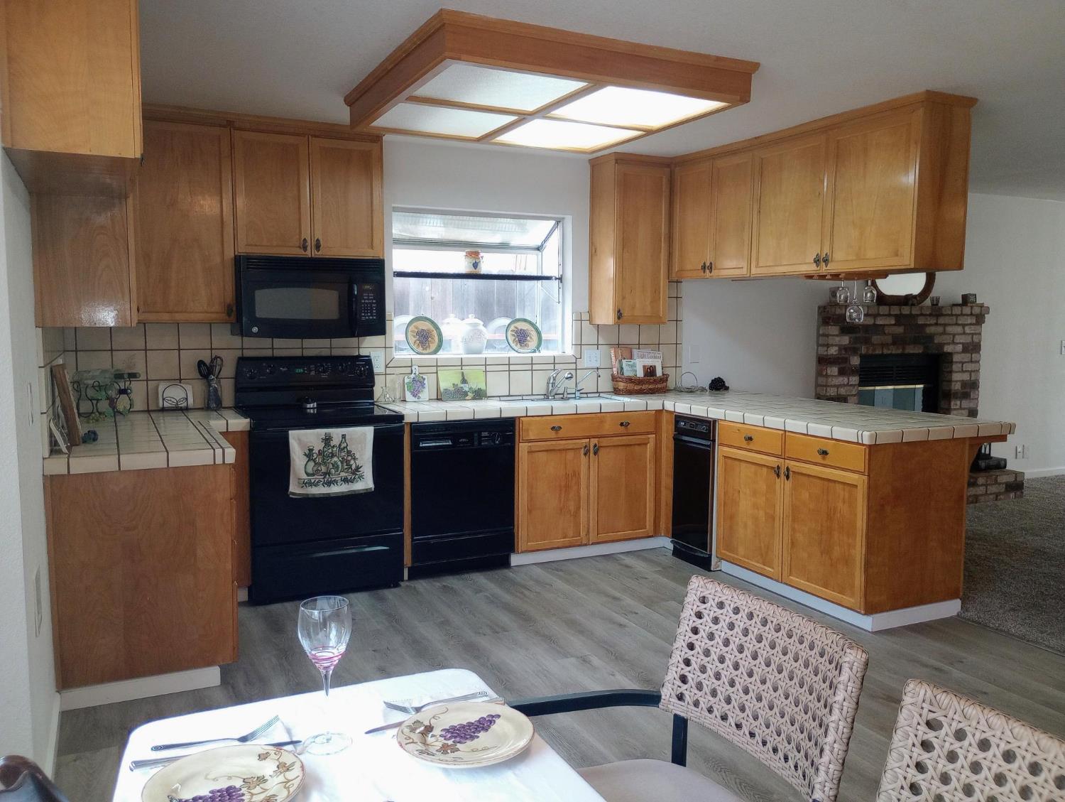 1432 Don Pedro Road Ceres, CA 95307 - Photo 8 of 56 a kitchen with stainless steel appliances granite countertop a sink a stove a microwave a refrigerator and cabinets