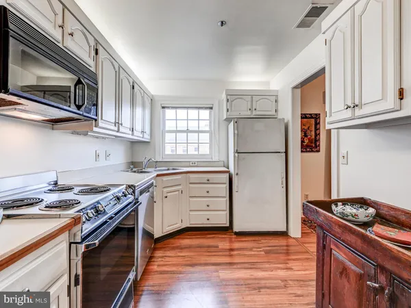 a kitchen with stainless steel appliances granite countertop a refrigerator stove and a sink