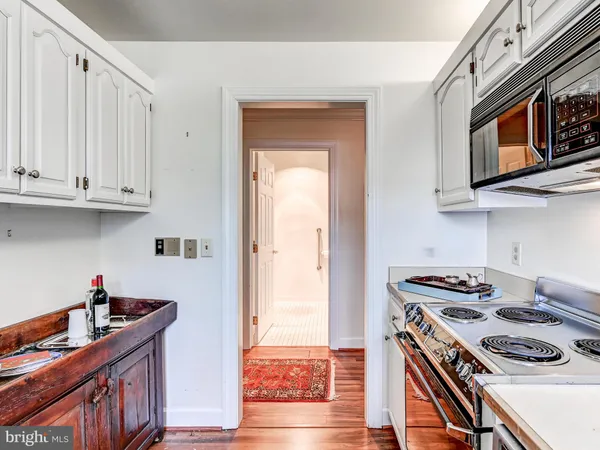 a kitchen with stainless steel appliances granite countertop a stove and a microwave