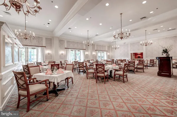 a large kitchen with a table and chairs