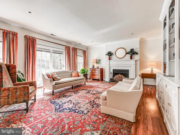 a living room with furniture a fireplace and a large window