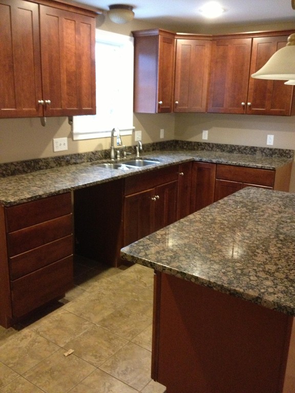 860 Podunk Road East Brookfield, MA 01515 - Photo 11 of 18 a kitchen with a sink a stove and cabinets