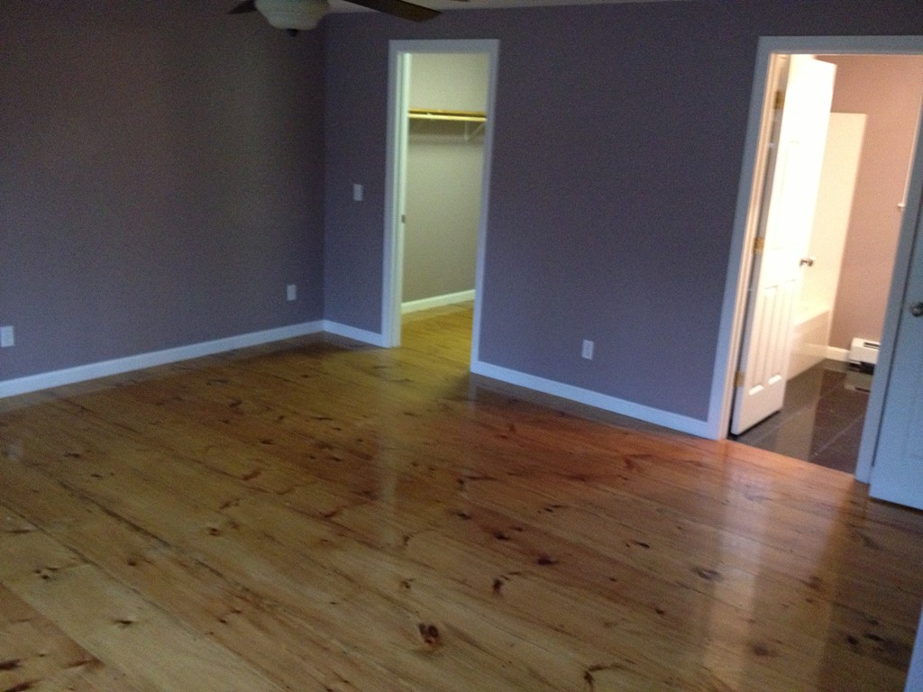 860 Podunk Road East Brookfield, MA 01515 - Photo 13 of 18 an empty room with wooden floor and windows