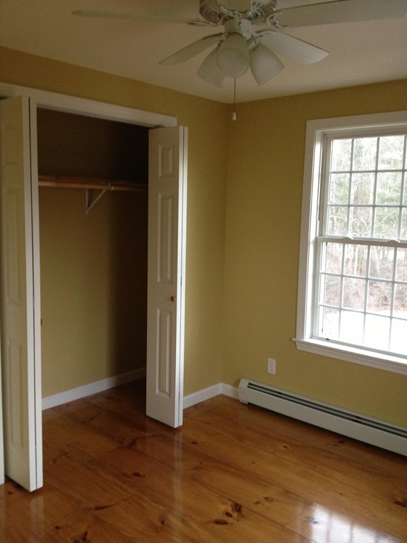 860 Podunk Road East Brookfield, MA 01515 - Photo 14 of 18 an empty room with wooden floor closet and windows