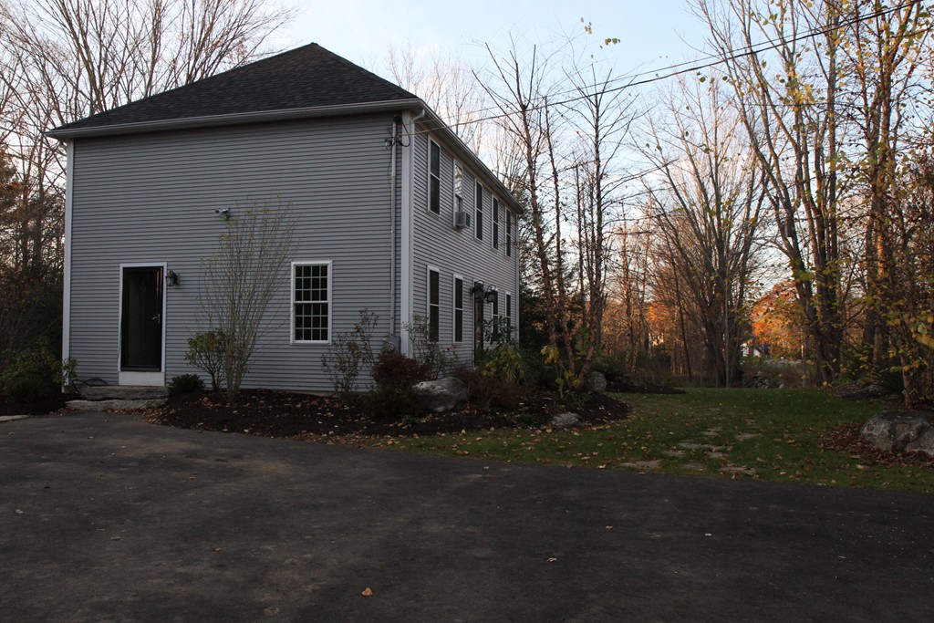 860 Podunk Road East Brookfield, MA 01515 - Photo 6 of 18 a front view of a house with a yard