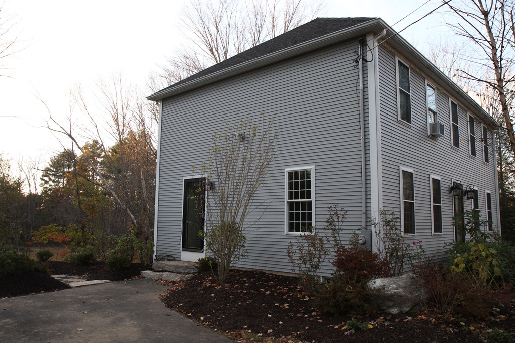 860 Podunk Road East Brookfield, MA 01515 - Photo 7 of 18 a view of a house with yard and a garden