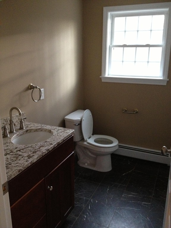 860 Podunk Road East Brookfield, MA 01515 - Photo 8 of 18 a bathroom with a granite countertop toilet sink and window