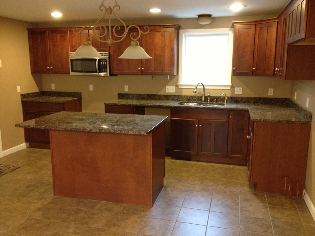 860 Podunk Road East Brookfield, MA 01515 - Photo 9 of 18 a kitchen with stainless steel appliances granite countertop a sink counter space and cabinets
