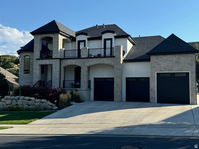 614 East High Lane Alpine, UT 84004 - Photo 5 of 75 French country home featuring stone siding, stucco siding, concrete driveway, and a balcony