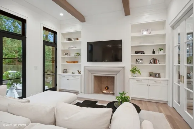 a living room with furniture a flat screen tv and a fireplace