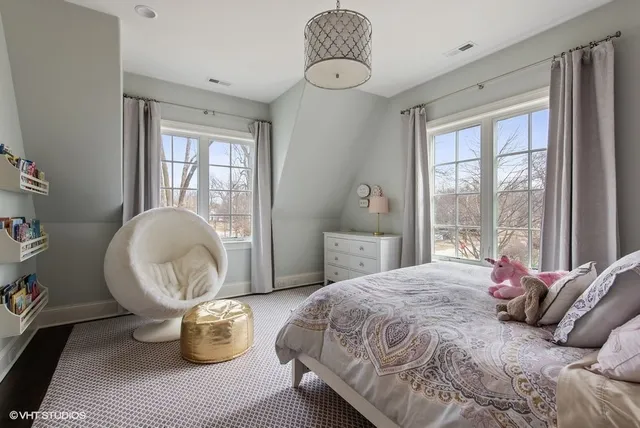 a spacious bedroom with a bed and window