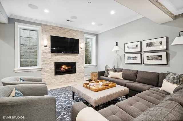 a living room with furniture a flat screen tv and a fireplace