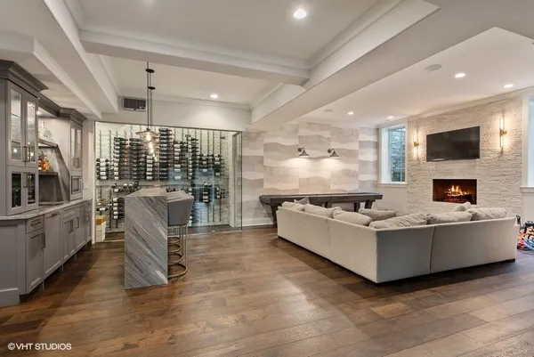 a dining room with stainless steel appliances granite countertop a table chairs and chandelier