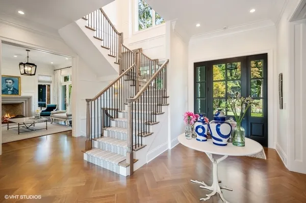 a view of an entryway and hall with wooden floor