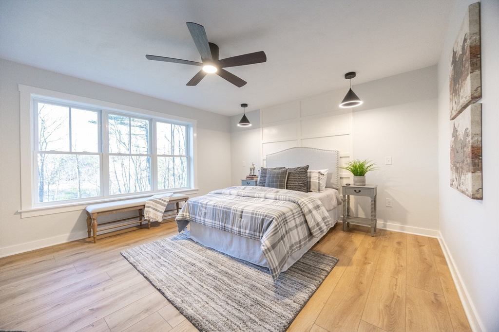 Lot 4 Pickering Road Blackstone, MA 01504 - Photo 12 of 19 a spacious bedroom with a large bed and a chandelier