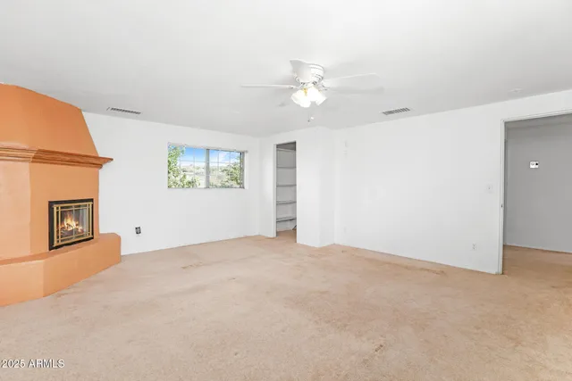 a view of an empty room and wooden floor