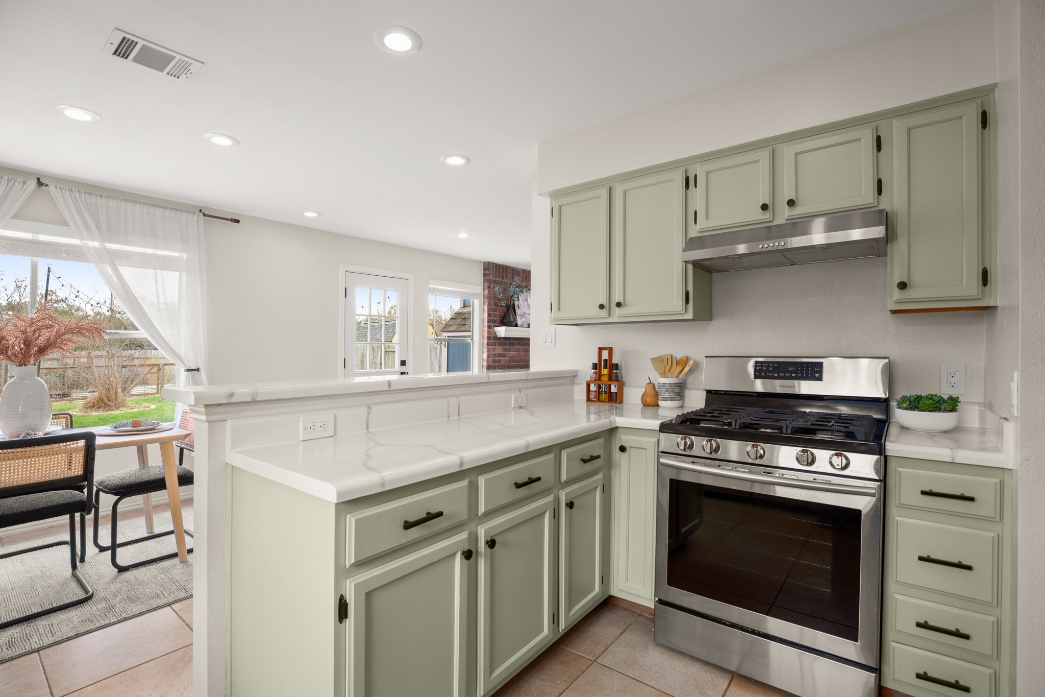 1302 Rambling Trail Cedar Park, TX 78613 - Photo 13 of 26 a kitchen with stainless steel appliances white cabinets and a stove top oven