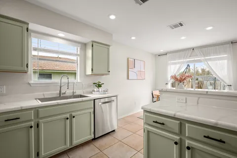 a kitchen with a sink and large window