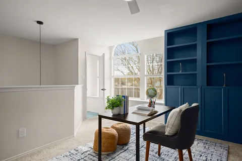 a workspace with furniture and a window