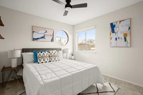 a bedroom with a large bed and a window