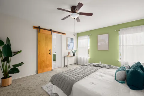 a bedroom with a bed and a potted plant