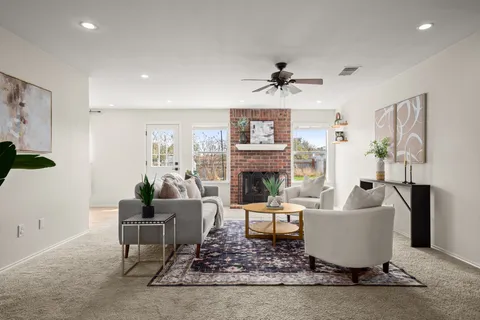 a living room with furniture and a fireplace
