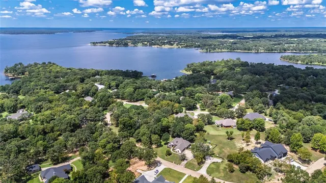 an aerial view of a houses with a lake view