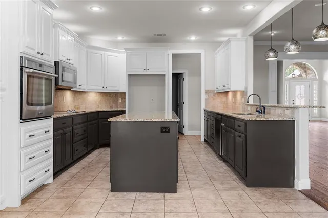 a kitchen with kitchen island cabinets and refrigerator