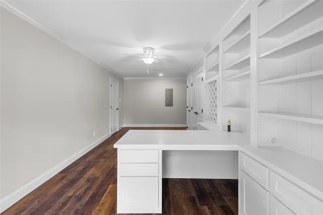 a view of an empty room with a window and a ceiling fan