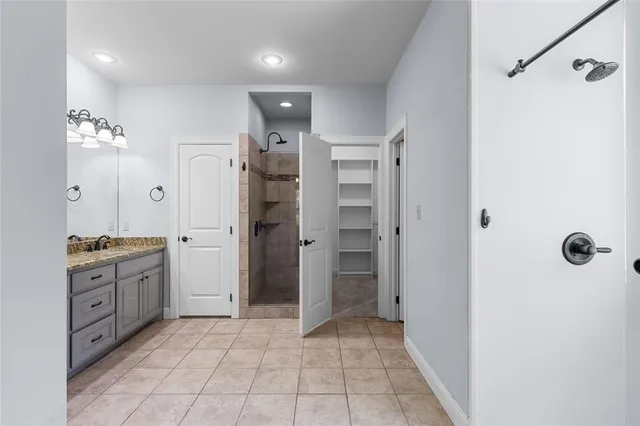 a bathroom with a shower sink and mirror