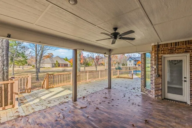 a view of a livingroom with wooden floor and a ceiling fan
