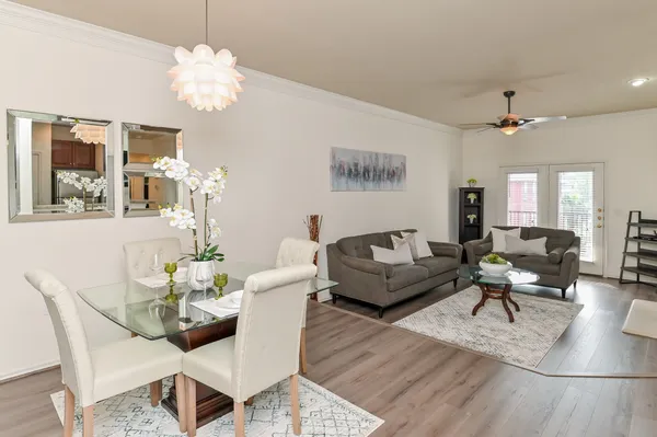 a living room with furniture chandelier and a table