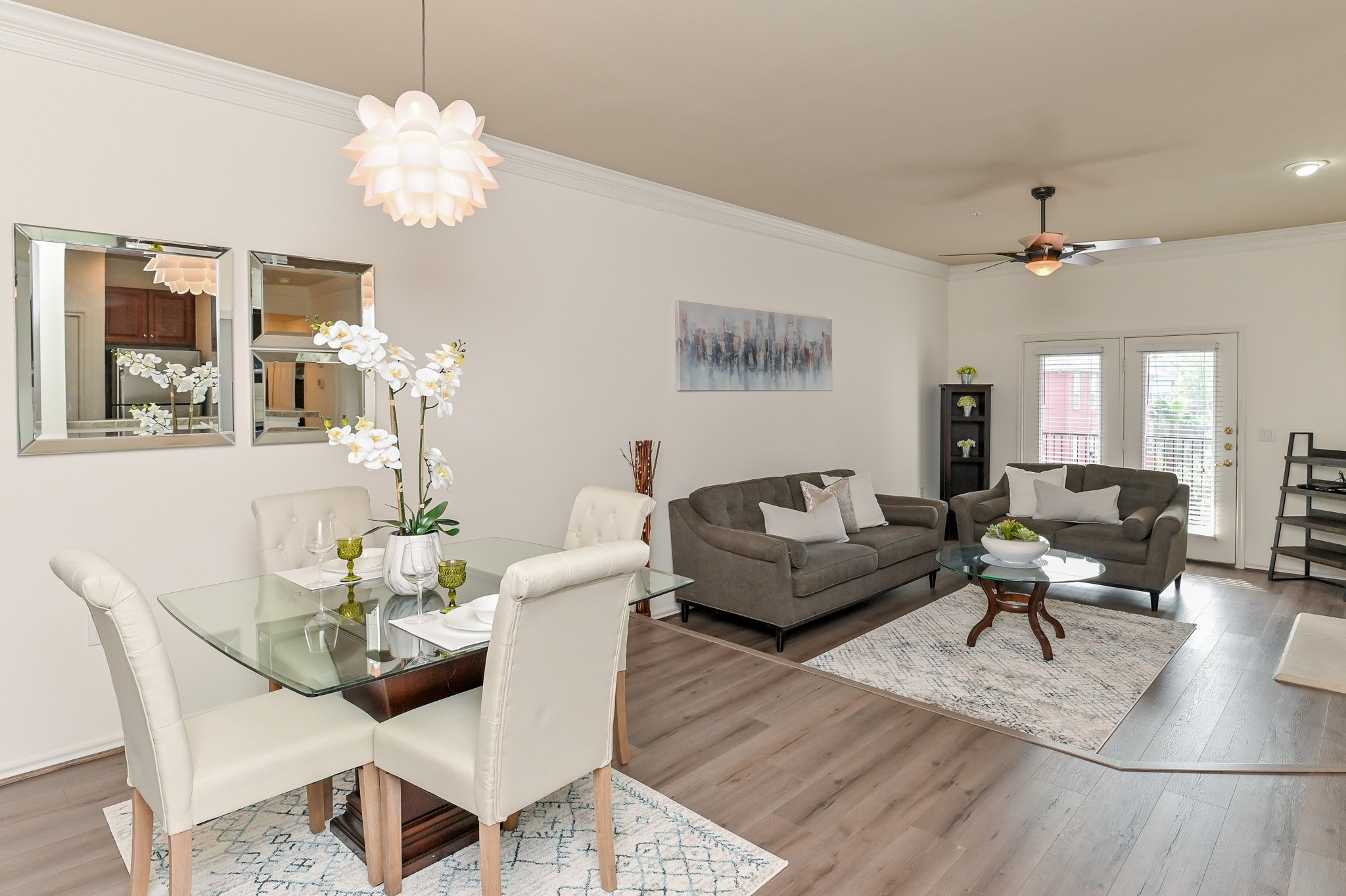 a living room with furniture chandelier and a table