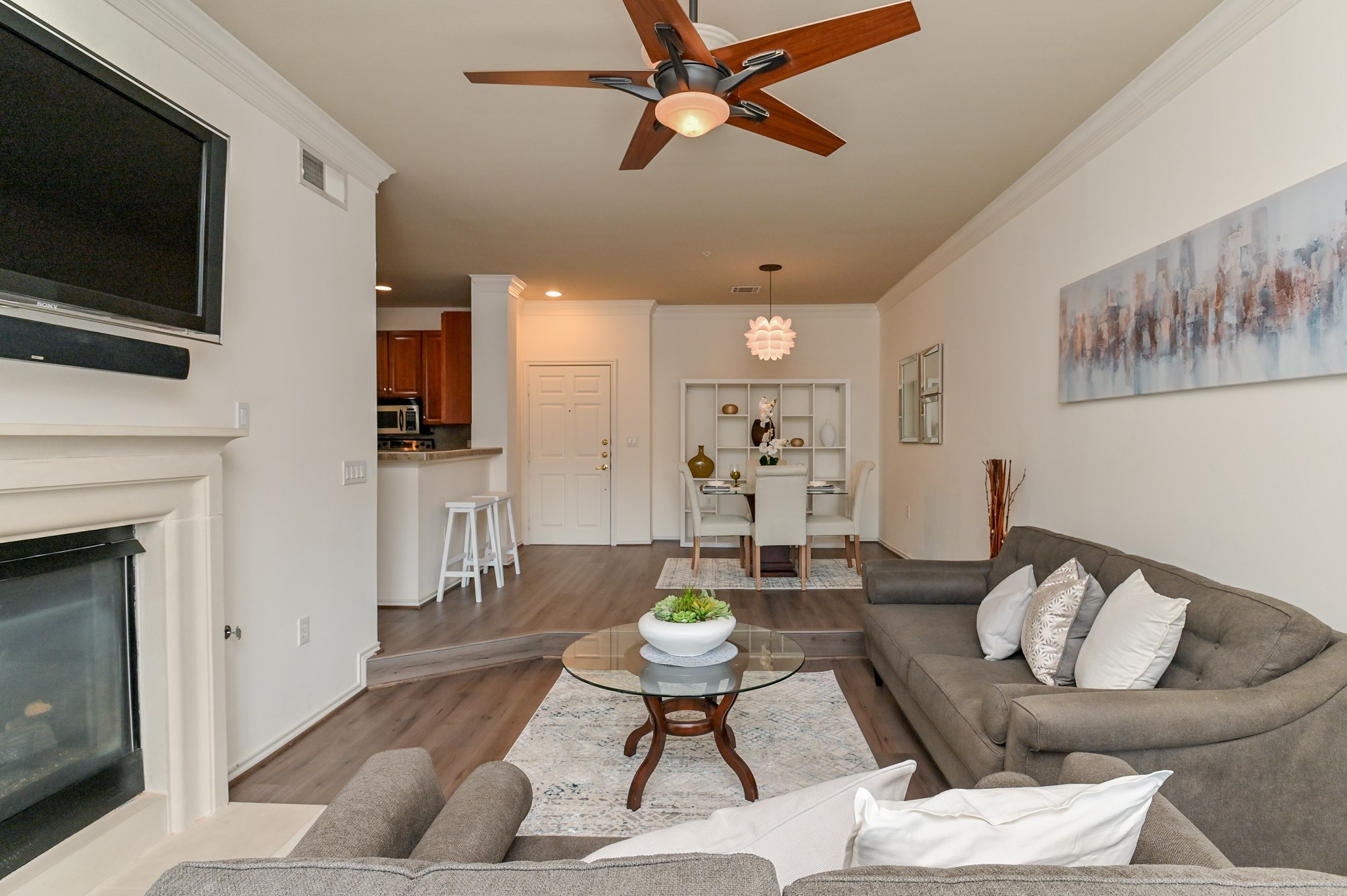 2400 McCue Road, Unit 443 Houston, TX 77056 - Photo 9 of 31 a living room with furniture a flat screen tv and a fireplace